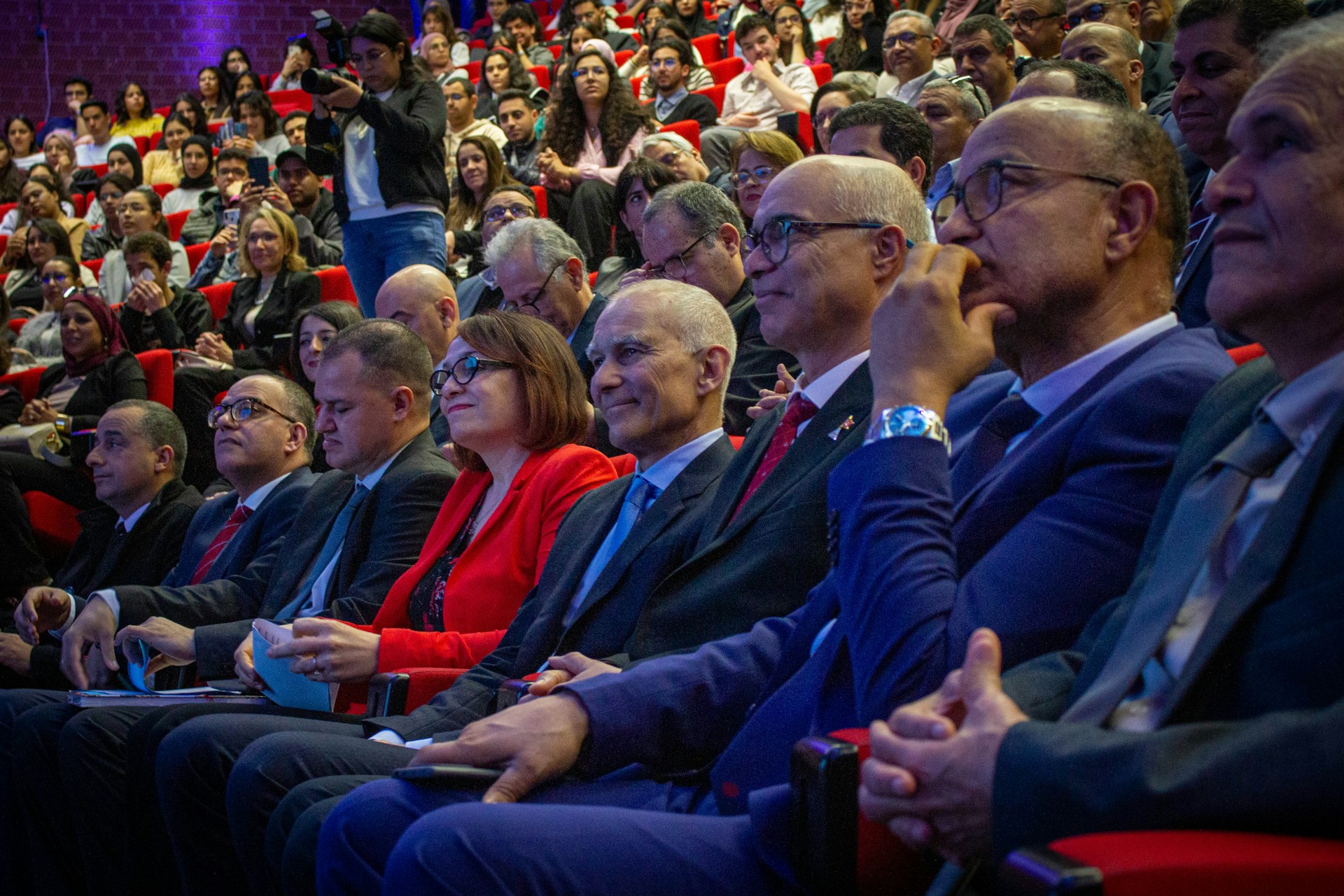Conference audience seated in an auditorium during a drug discovery event